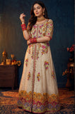 Full-length view of an off-white embroidered long gown with an ornate scalloped multi-colored hemline.