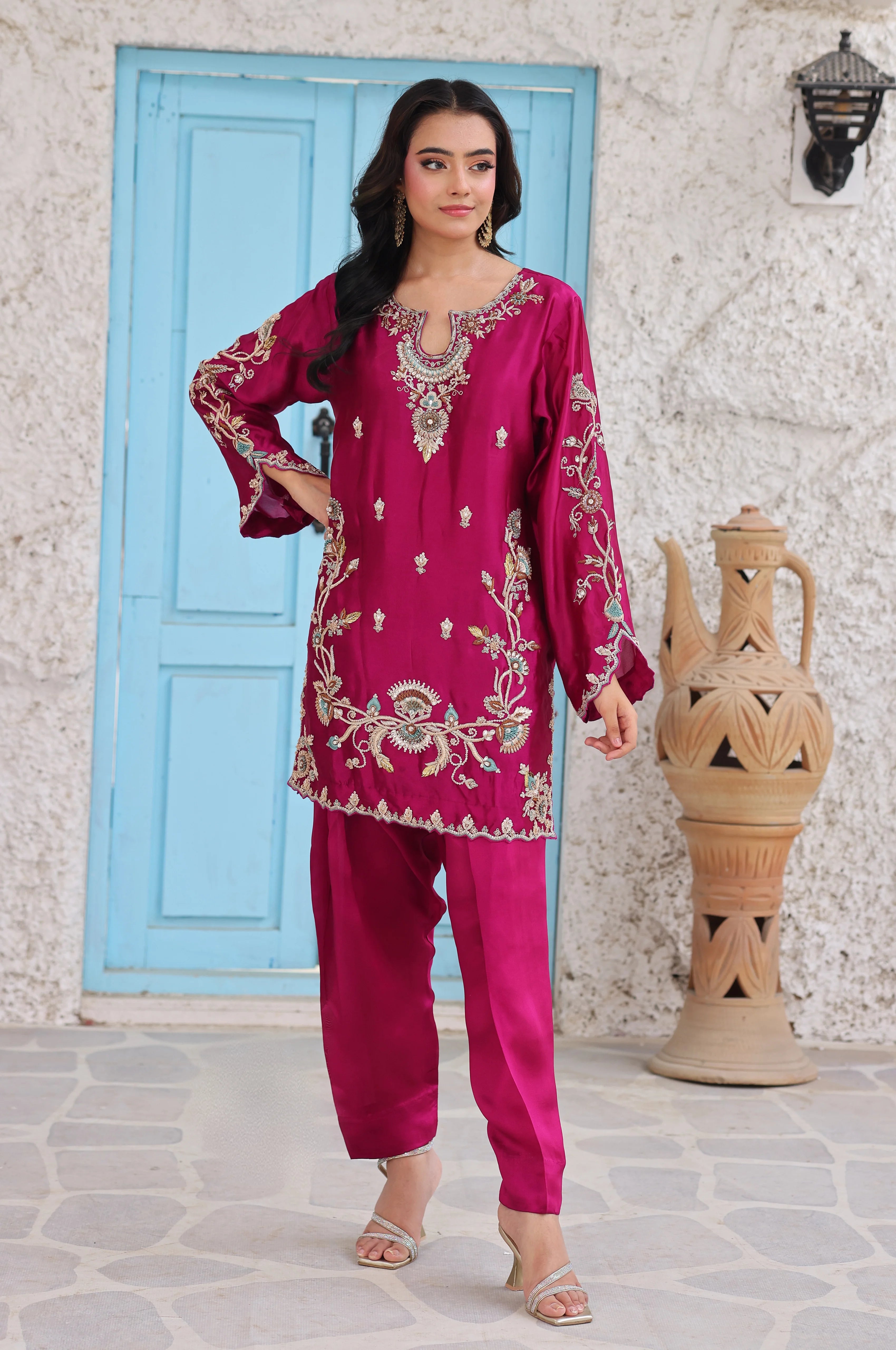 Magenta embroidered silk tunic paired with matching silk trousers.