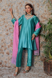 Full-length view of a teal silk tunic set with an embellished neckline, matching straight pants, and a pink dupatta.
