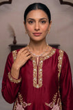 Close-up of embroidered neckline on a maroon silk long kurti with gold detailing.
